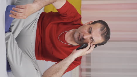 Vertical-video-of-Man-talking-on-the-phone-arguing.